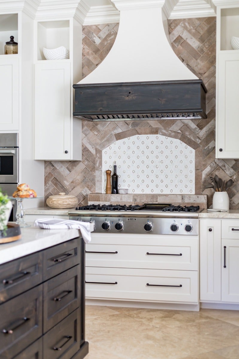 Bright white kitchen with large black handles.